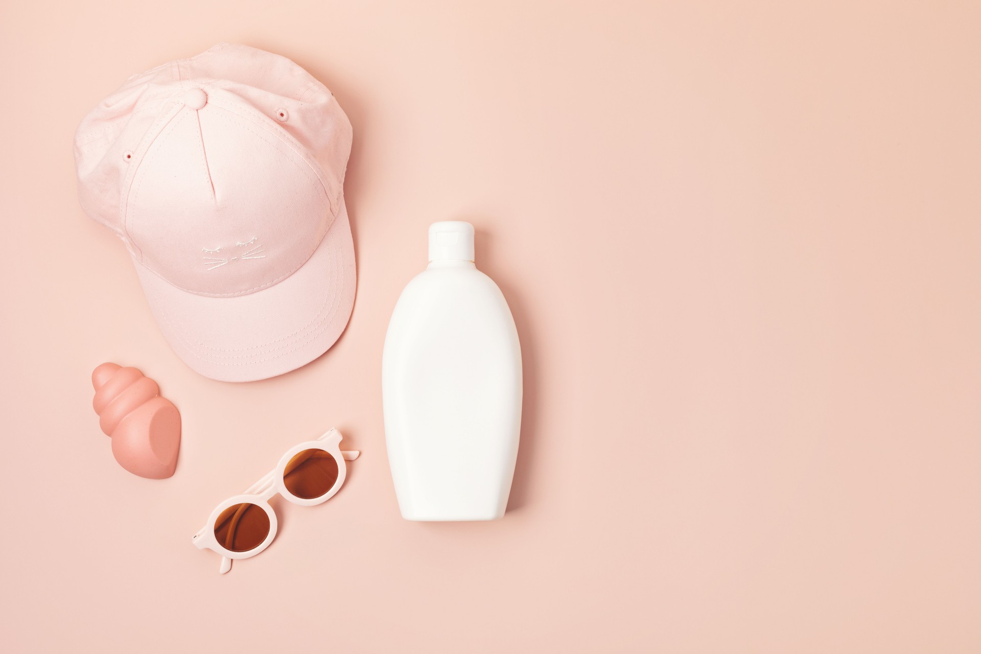 Kids summer accesories and sun screen bottle for sunny vacations